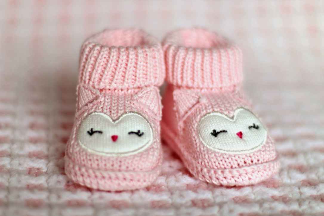 close up of pink baby booties